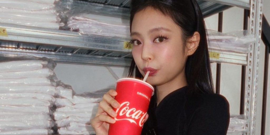 Jennie drinking Coca-Cola